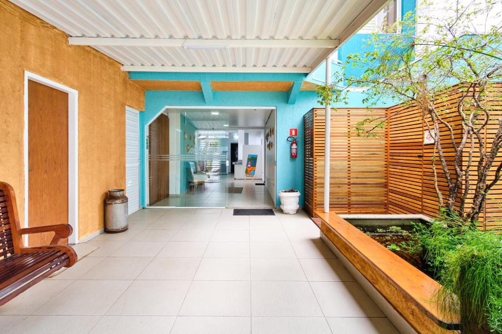 a hallway of an office building with a bench at Green Haven Residence in Ubatuba