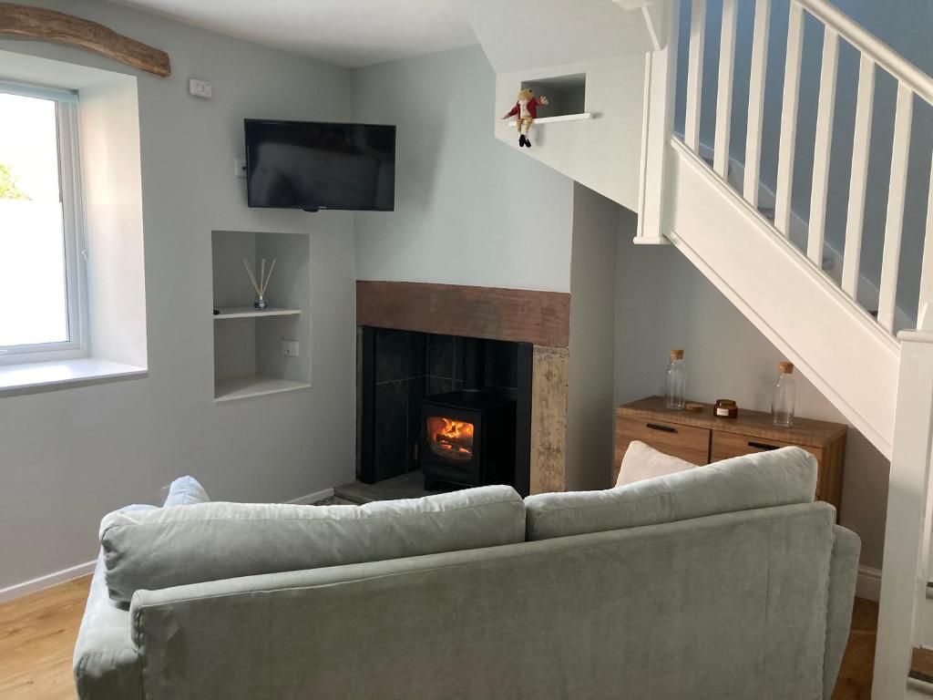 a living room with a couch and a fireplace at The Annex in Carlisle