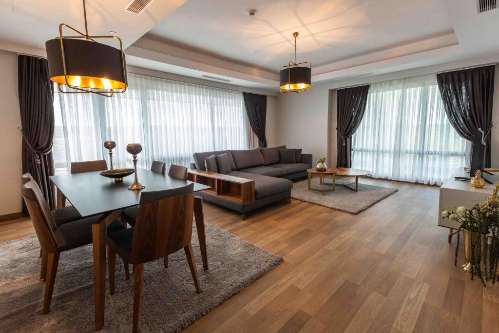 a living room with a table and a couch at Maslak Aparts in Istanbul