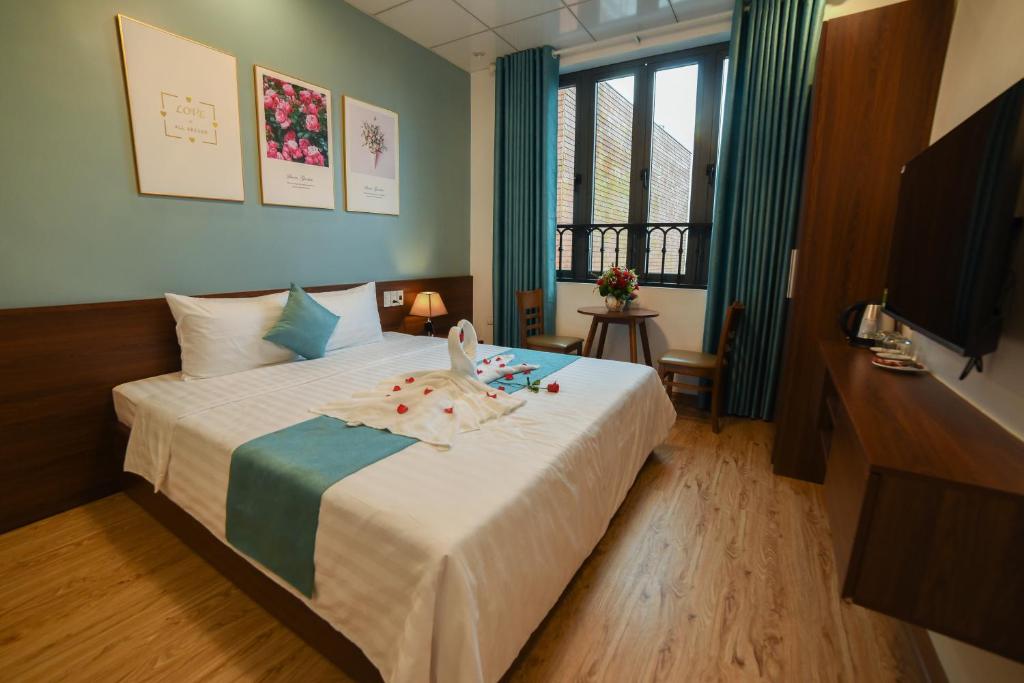 a bedroom with a bed with a child on it at An-An Homestay Huế - Near Walking Street in Hue
