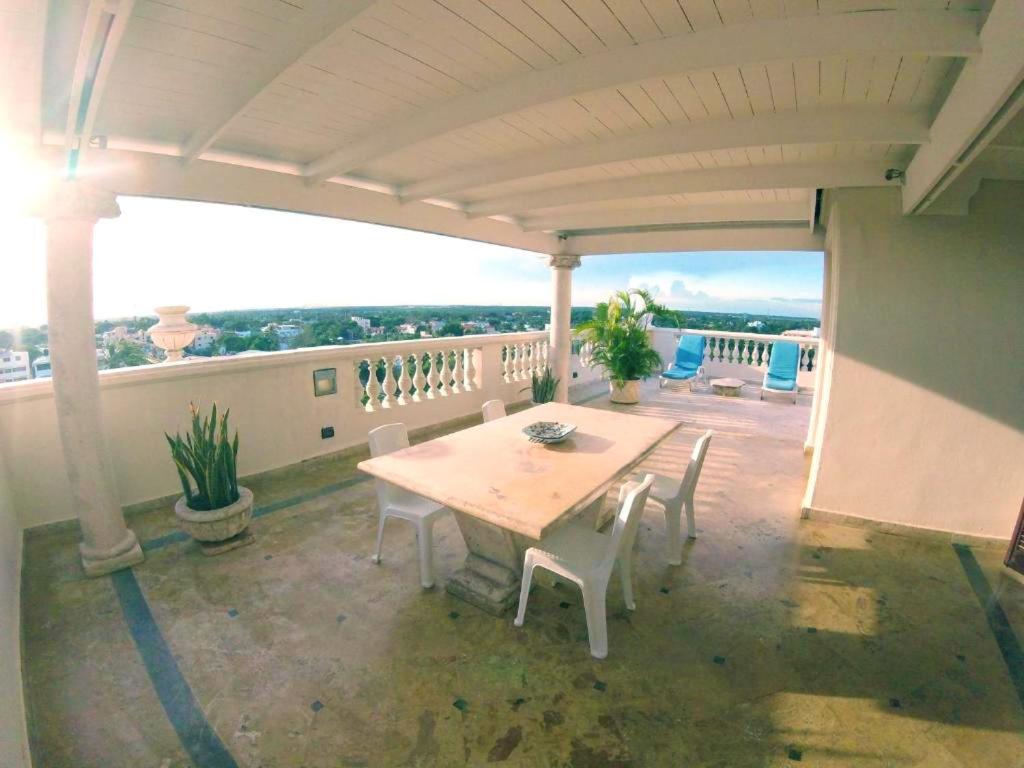 a patio with a table and chairs on a balcony at One bedroom apartement with sea view jacuzzi and furnished terrace at Boca Chica in Boca Chica