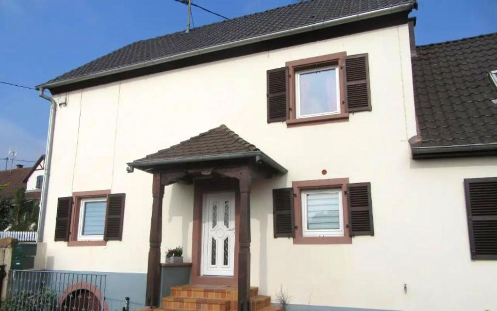 a white house with brown shutters on it at Maison de 2 chambres avec jardin clos et wifi a Gottenhouse in Gottenhouse