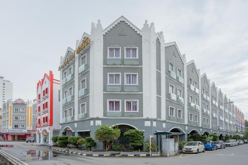 a large gray building on a city street at Euro Rich Hotel Melaka in Malacca