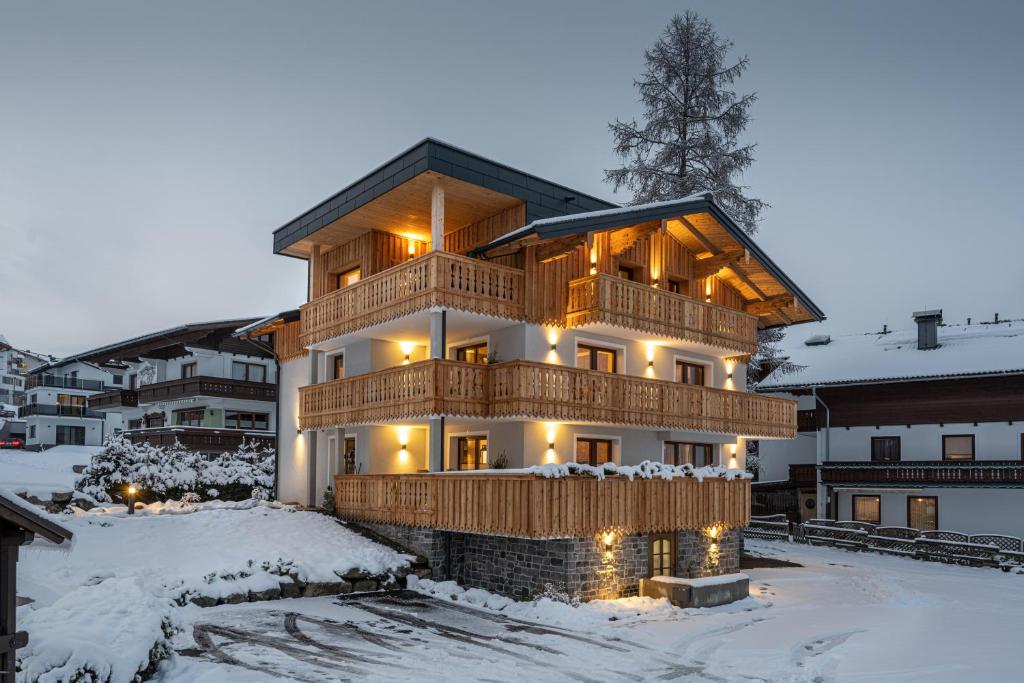 a large house with a deck in the snow at sWiederkehr in Schladming