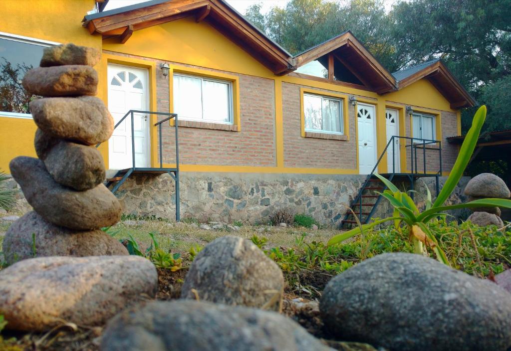 a stack of rocks in front of a house at El Mundo Interior in Capilla del Monte