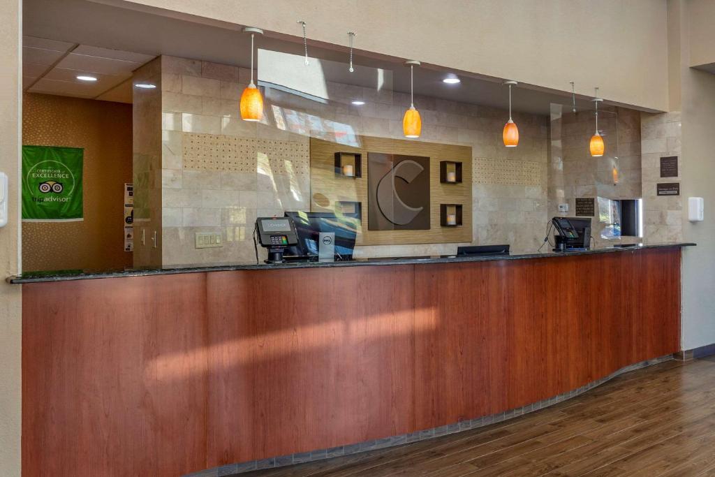 a lobby with a large wooden bar in a hospital at Comfort Inn At the Park in Fort Mill