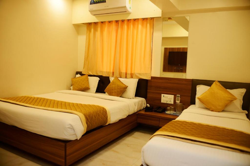 Ein Bett oder Betten in einem Zimmer der Unterkunft Hotel Ashyana - Near To Grant Road Station Mumbai