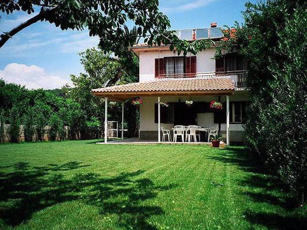 a house with a lawn in front of it at Hvar Guesthouse - Double bedroom with private bathroom in Jelsa