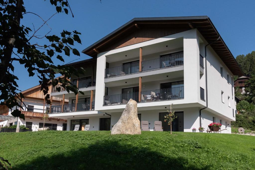 a building with a rock in front of it at Willmüllerhof in Perca