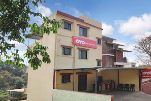 a building with a sign on the side of it at Hotel Nandanvan by Royal Stay in Lonavala