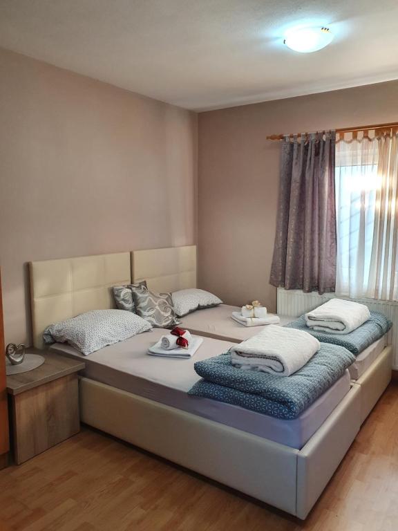 a bedroom with two beds with plates of food on them at Apartman "MILLAN" in Prijedor