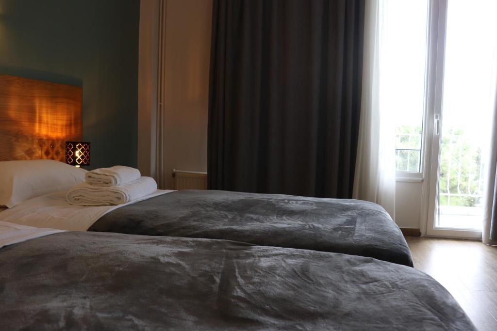 Postel nebo postele na pokoji v ubytování Hara Hotel