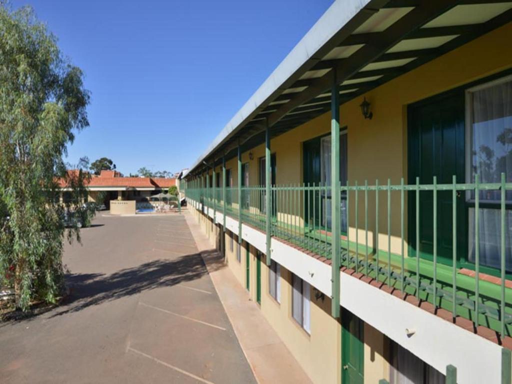 a building with a fence on the side of it at The Tower Hotel in Kalgoorlie