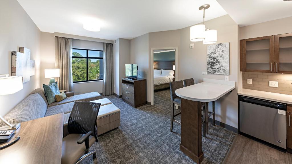 a living room with a couch and a table at Staybridge Suites - Naples - Marco Island by IHG in Naples