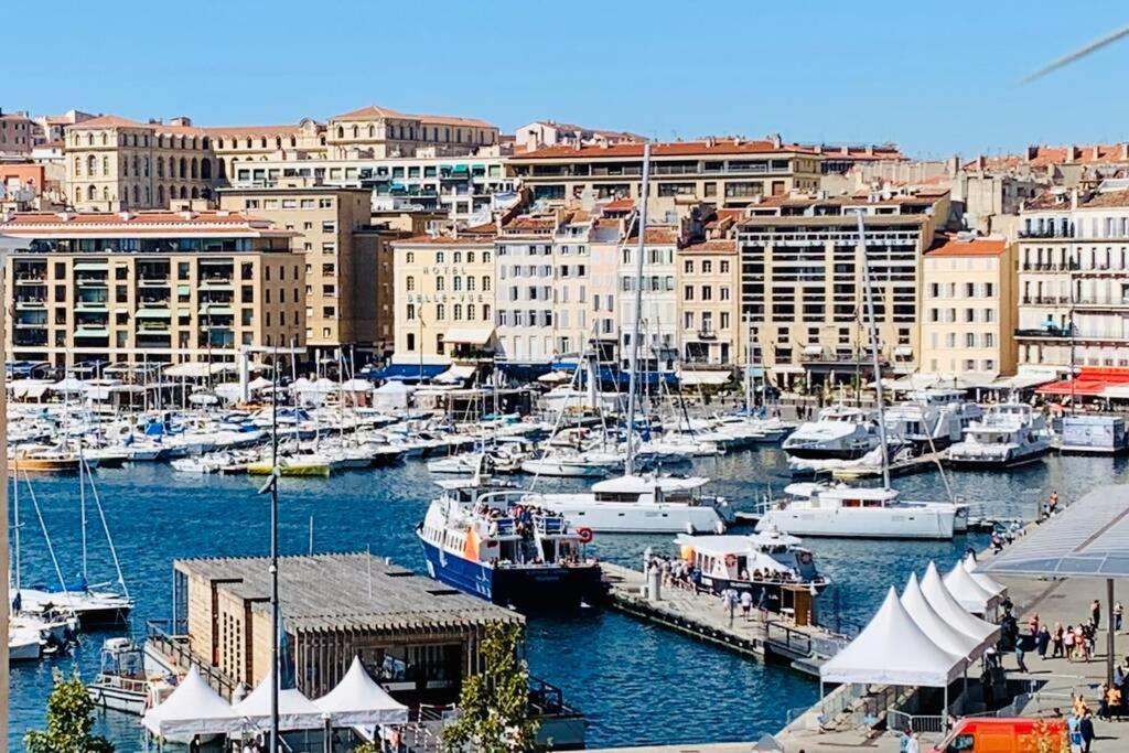 a group of boats docked in a harbor with buildings at Le Phocéen : T4 balcon vue Vieux-Port in Marseille