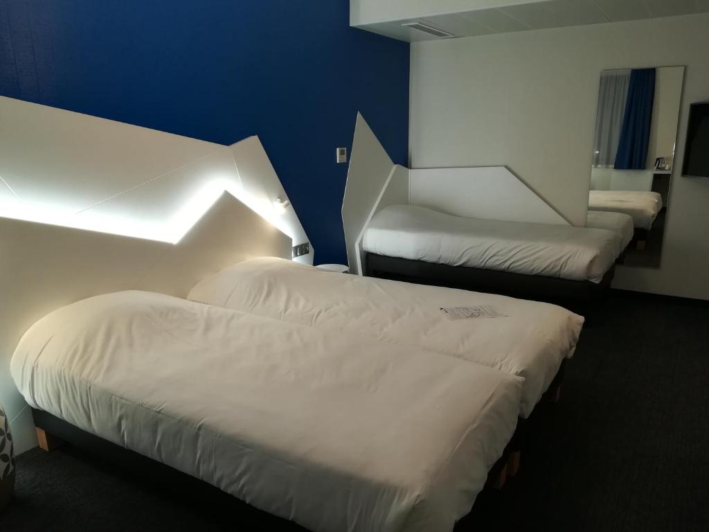 Postel nebo postele na pokoji v ubytování Hôtel ORIGAMI