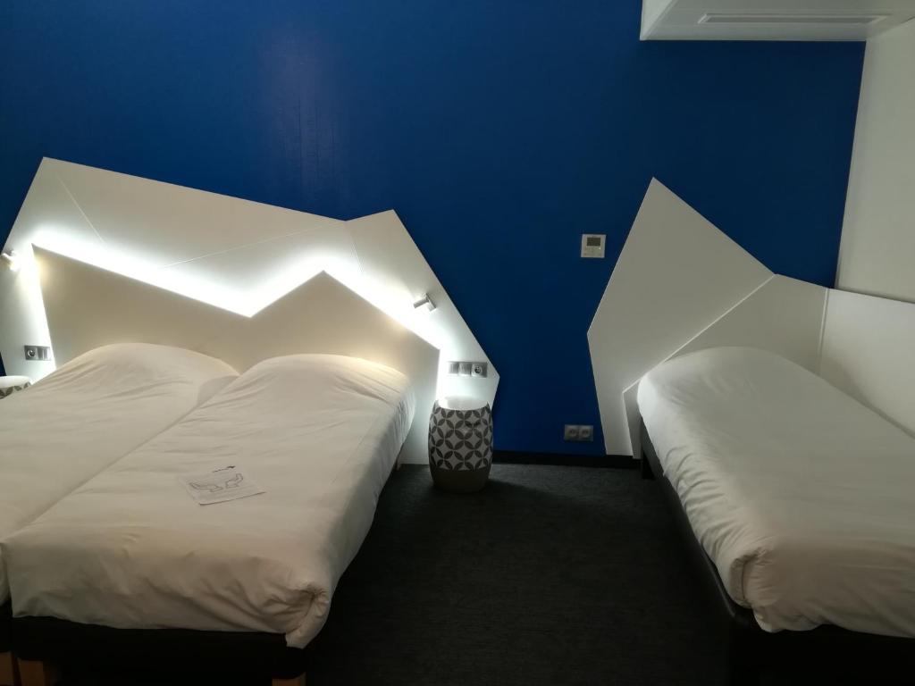 Postel nebo postele na pokoji v ubytování Hôtel ORIGAMI