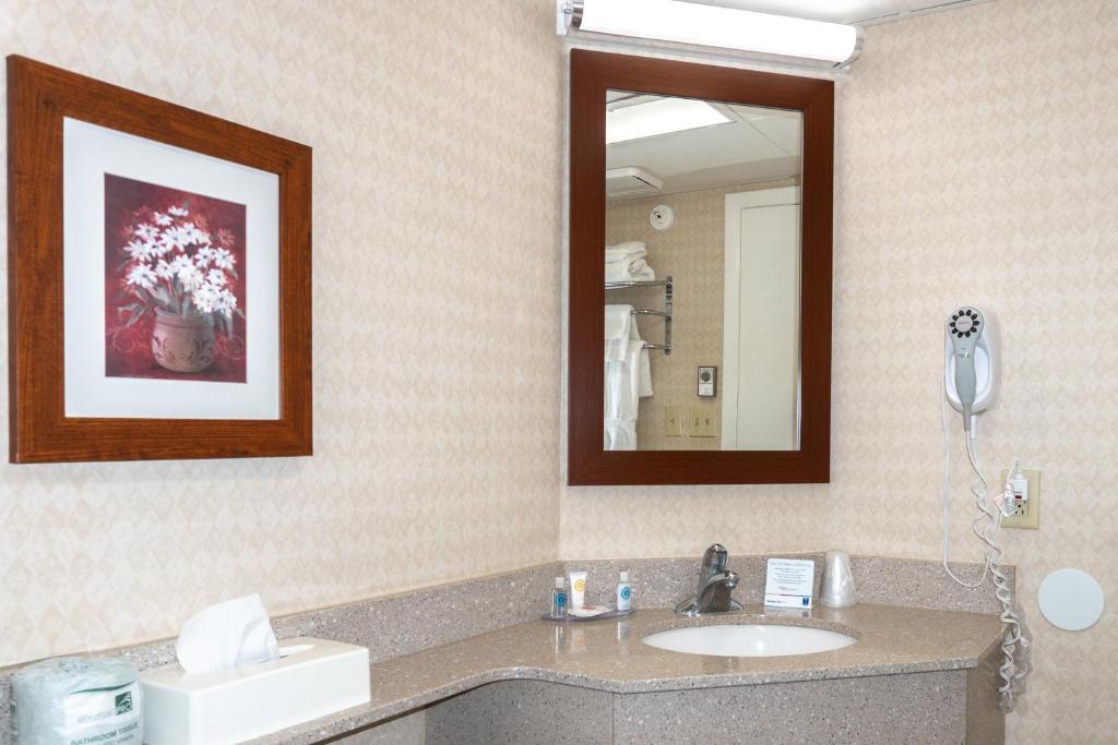 a bathroom with a sink and a mirror at Comfort Inn Ocean City Boardwalk in Ocean City
