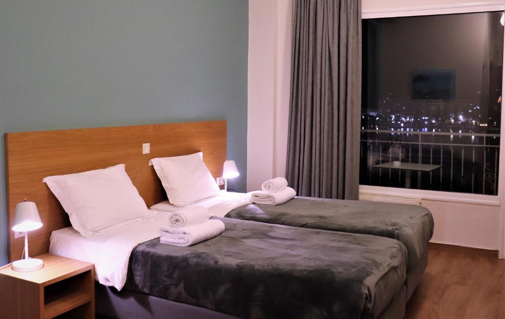 Postel nebo postele na pokoji v ubytování Hara Hotel