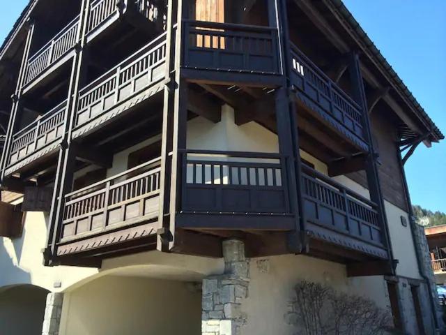 a building with balconies on the side of it at Appartement Courchevel le Praz in Courchevel