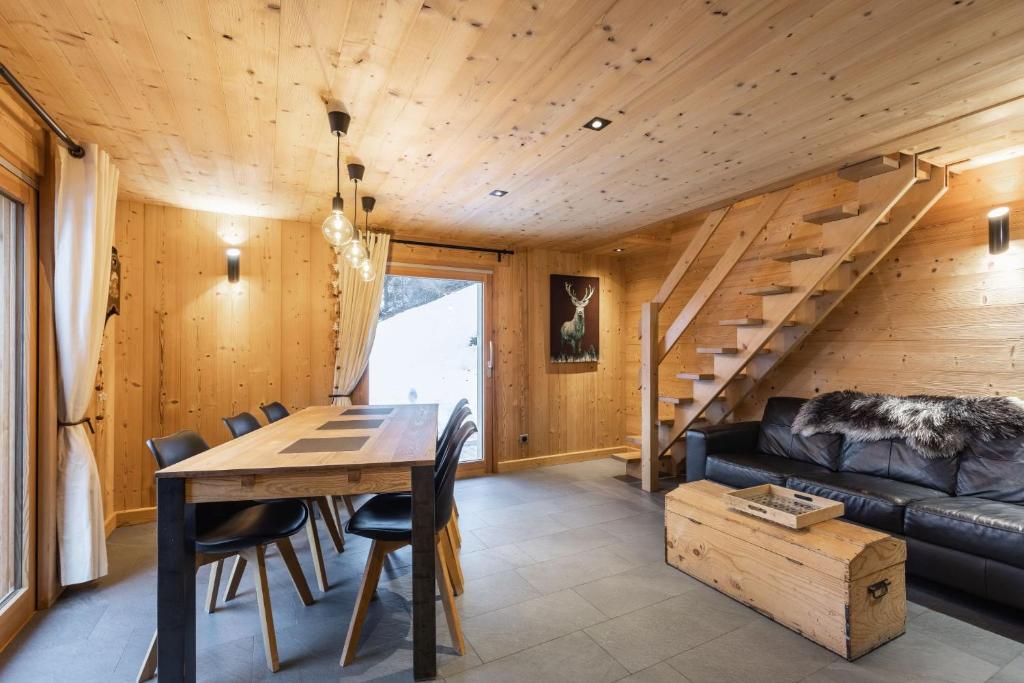 a living room with a table and a couch at Chalet Socali Le Grand Bornand in Le Grand-Bornand