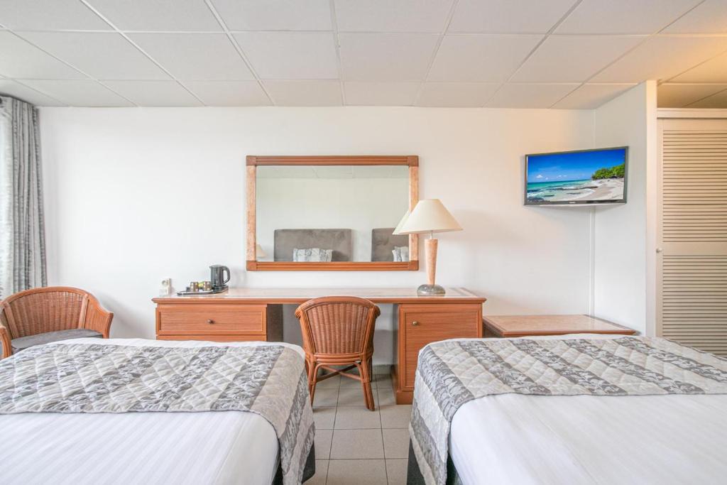 Postelja oz. postelje v sobi nastanitve Karibea La Valmenière Hôtel