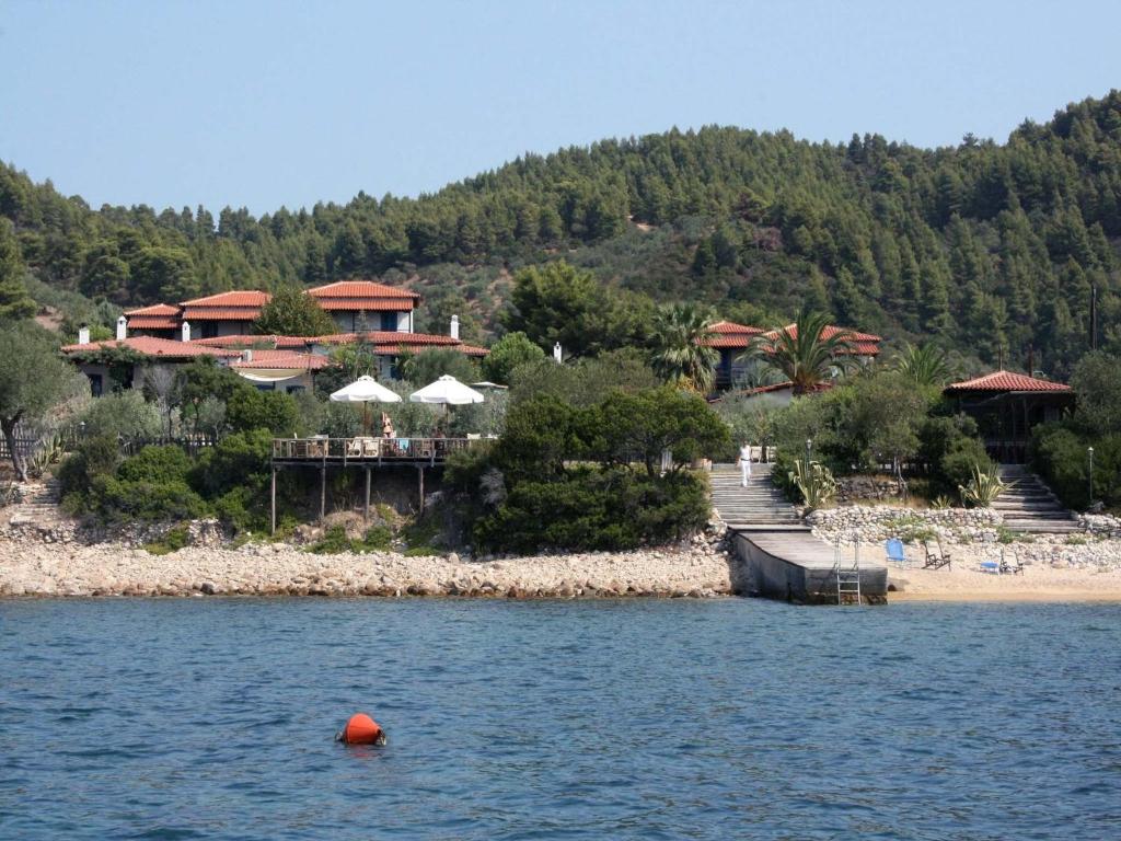 a resort on the shore of a body of water at Skites Hotel Bungalows in Ouranoupoli