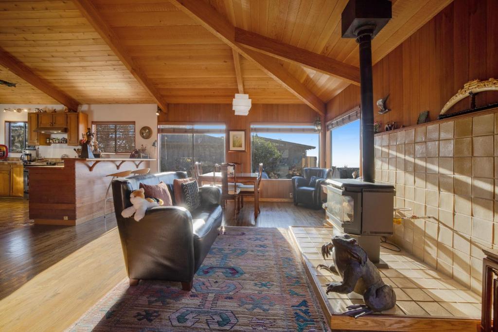 a living room with a couch and a stove at Nature's Paradise in Gualala