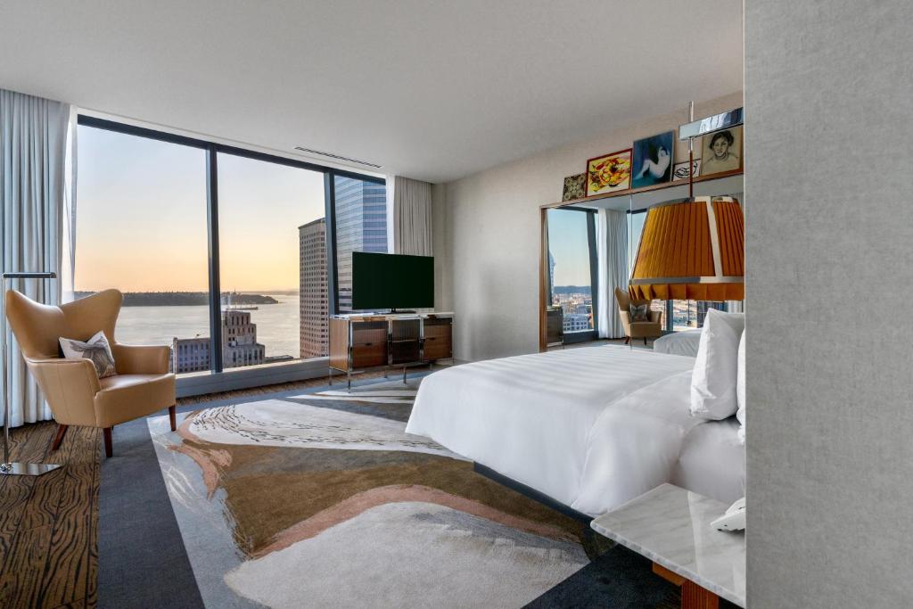 a hotel room with a large bed and a large window at Lotte Hotel Seattle in Seattle