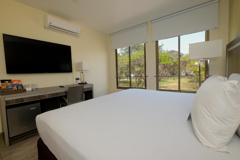 Postel nebo postele na pokoji v ubytování Rado Hotel - Quintanas