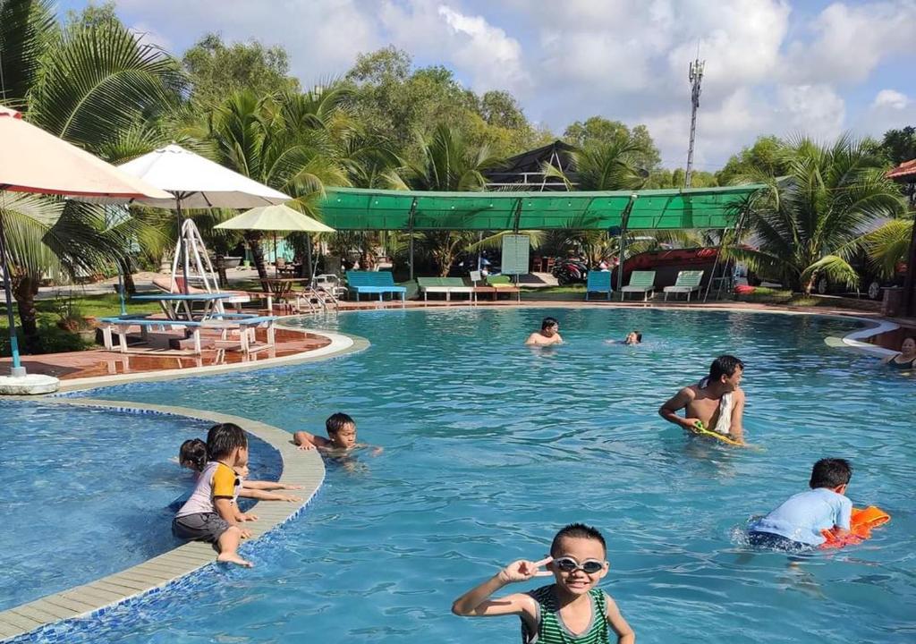 a group of people in a swimming pool at Resort Bao Anh Sunset Beach in Lagi