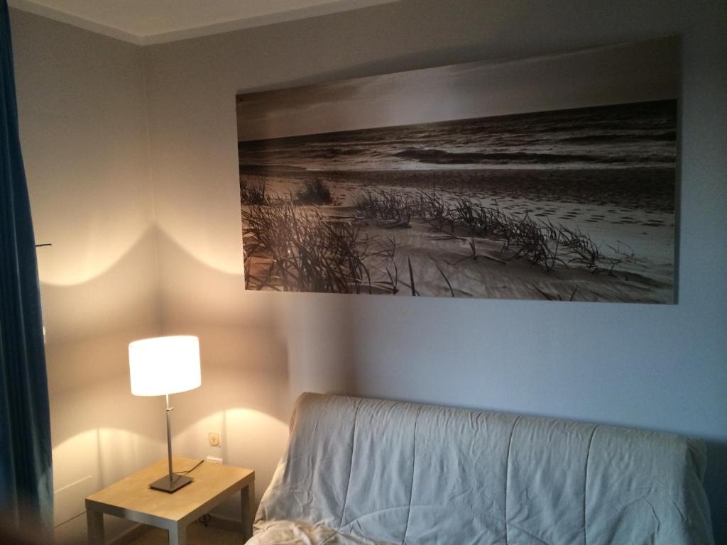a bedroom with a bed and a painting on the wall at Cosmopolitan Golf & Beach Resort in Tirrenia