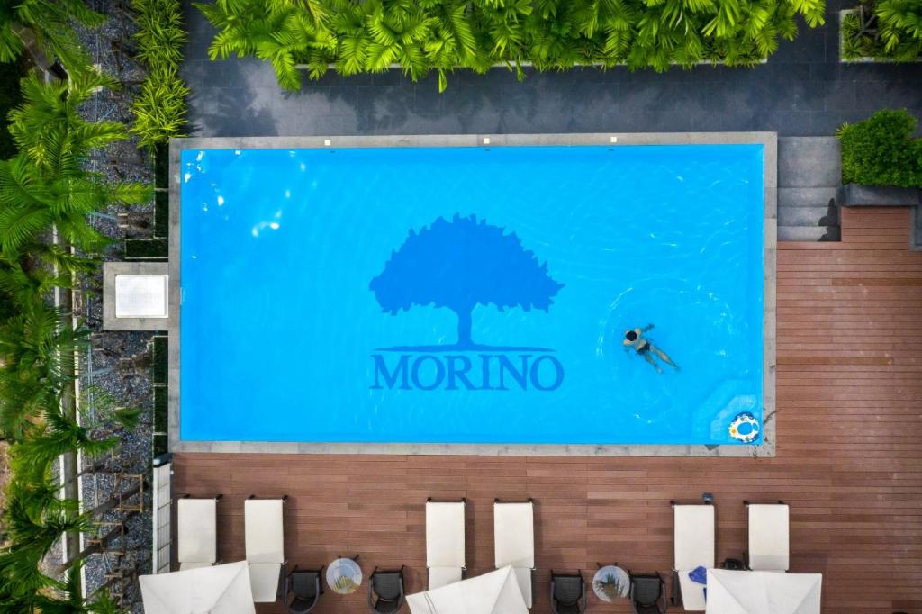 a sign for a mongolia resort with a person in the water at Morino Hotel Si Racha in Si Racha