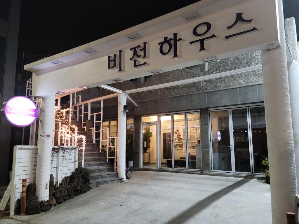 a building with a sign on the front of it at Jeju Vision House in Jeju