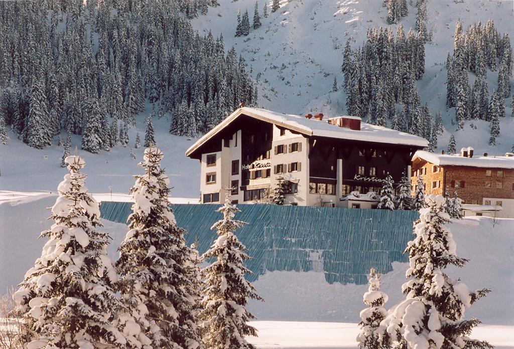 a house in the snow with snow covered trees at Kristiania Lech in Lech am Arlberg