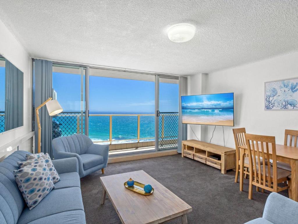 a living room with a view of the ocean at Ebbtide 38 On The Beach in Forster