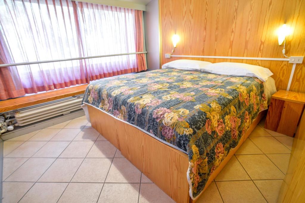 Postel nebo postele na pokoji v ubytování Res. Sole Alto appartamenti Solandra