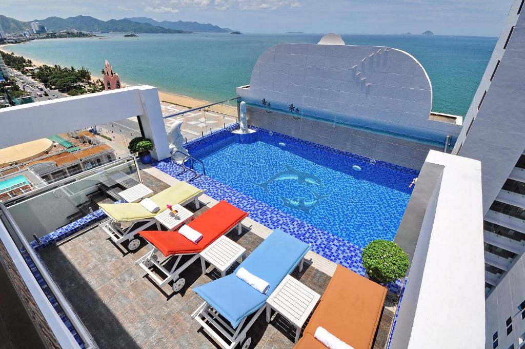 a swimming pool on top of a building with the ocean at Boss Hotel in Nha Trang