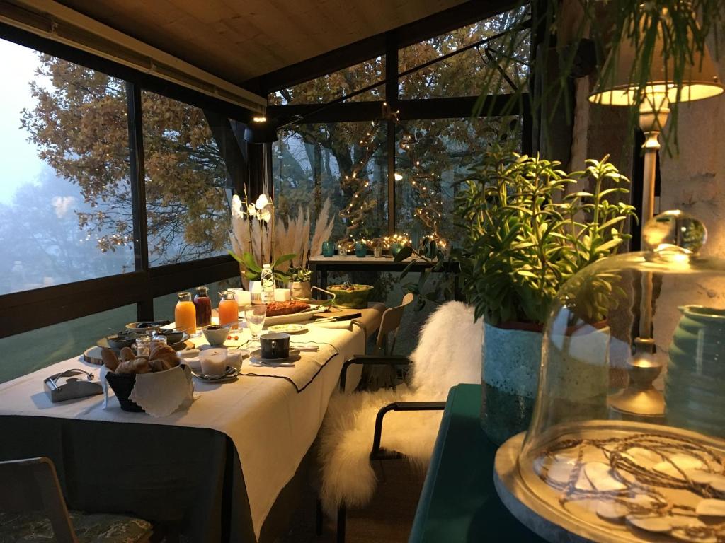 a group of tables in a room with windows at chambre de madel in Domme