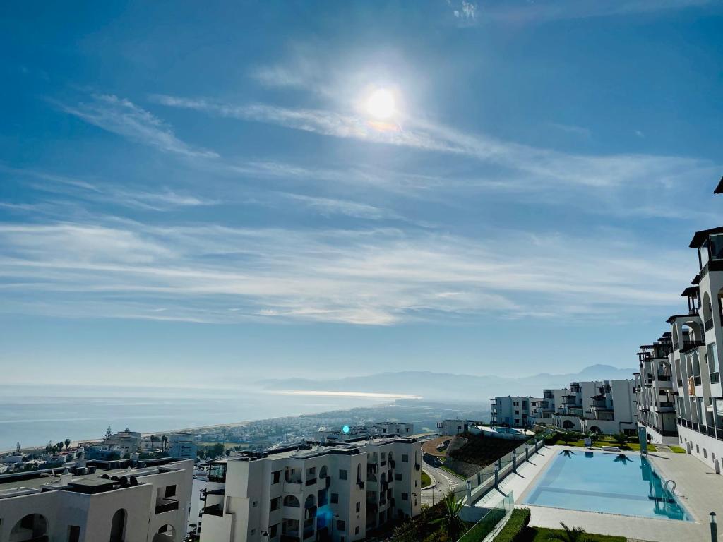 a view of a city with a pool and buildings at Appartement Bellavista - Cabo Negro in Cabo Negro