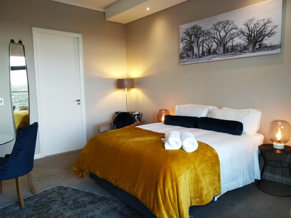 a bedroom with a bed with two white towels on it at The Residence Luxury Studio - Menlyn Maine in Pretoria