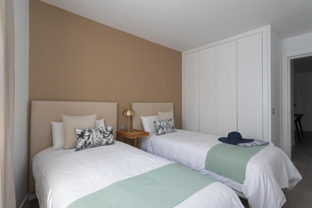 two beds sitting next to each other in a room at Royal Flats in Las Palmas de Gran Canaria