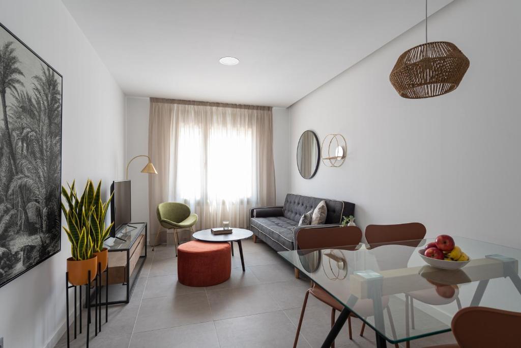 a living room with a couch and a table at Royal Flats in Las Palmas de Gran Canaria