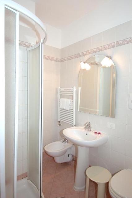 a bathroom with a sink and a toilet and a shower at Residenza Hotel San Maurizio in Venice