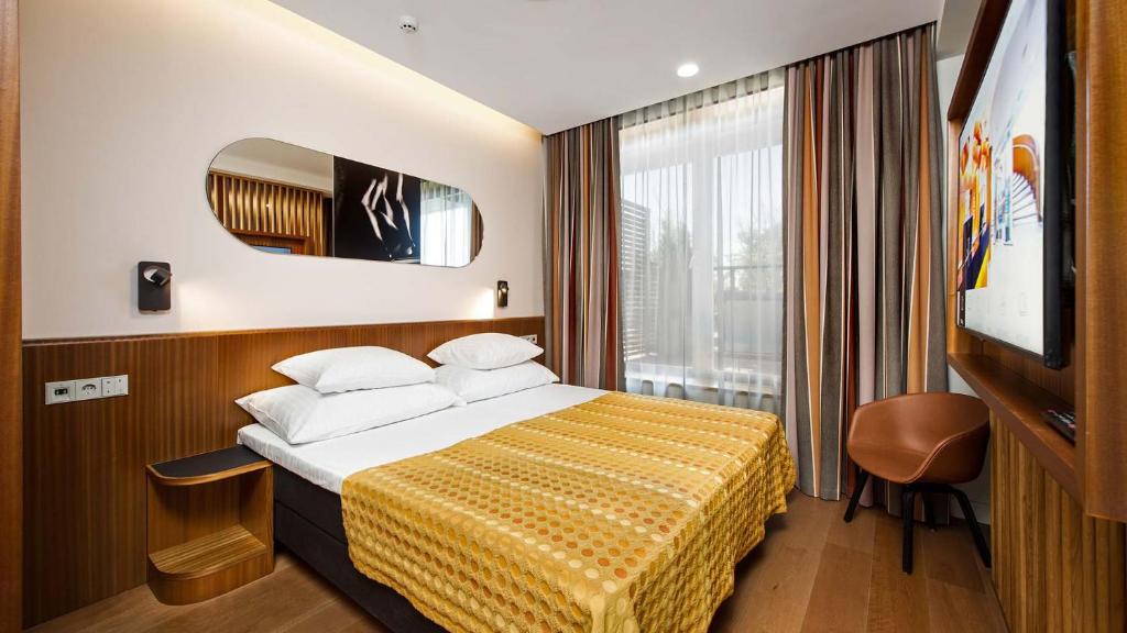 Postel nebo postele na pokoji v ubytování Hestia Hotel Kentmanni