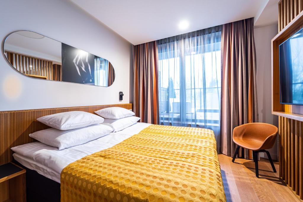 Postel nebo postele na pokoji v ubytování Hestia Hotel Kentmanni