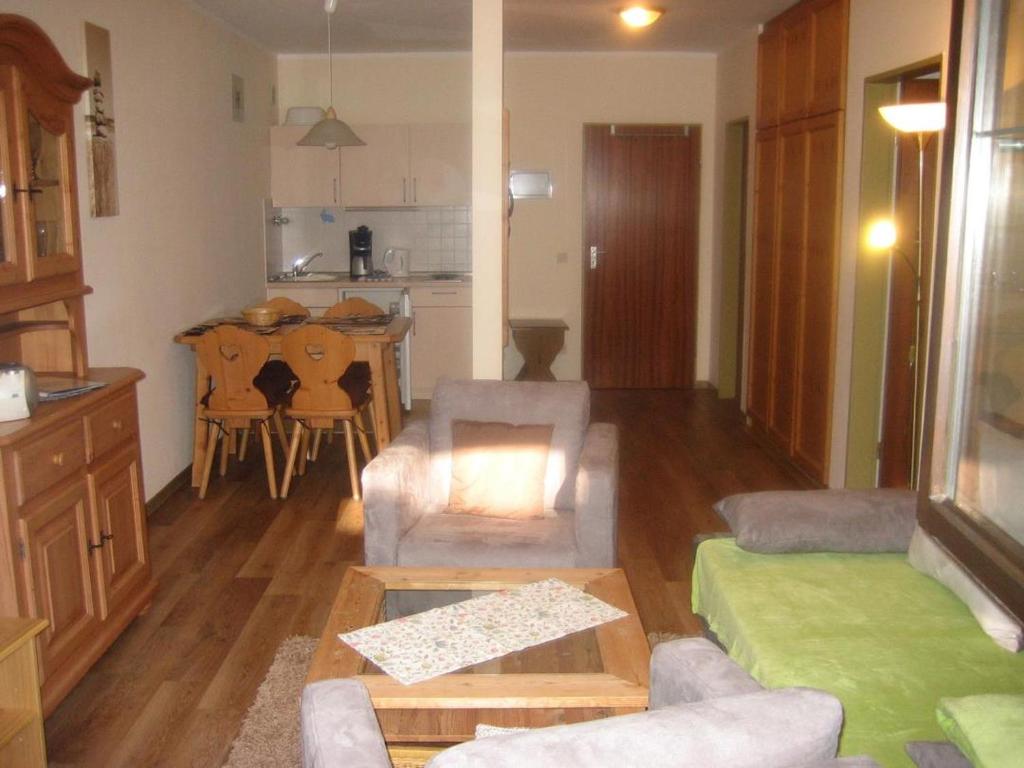 a living room with a couch and a table at Bergschlössl - Erdgeschosswohnung Hunde sind Willkommen in Oberaudorf