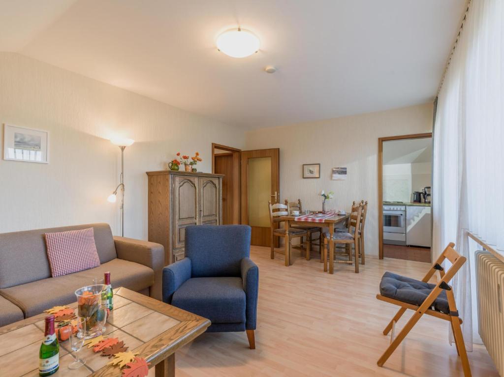 a living room with a couch and a table at Ferienwohnanlage Oberaudorf F8 mit Hallenbad und Sauna in Oberaudorf