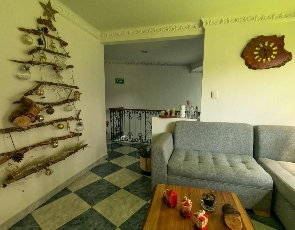 a living room with a christmas tree and a couch at NOGAL HOSTEL in Pereira