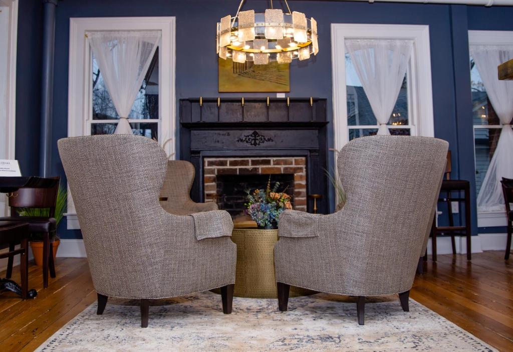 two chairs in a living room with a fireplace at The Colonial Inn in Hillsborough